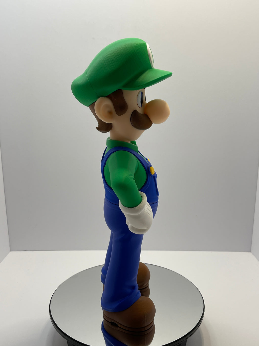 Full front view of video game figurine on mirrored turntable